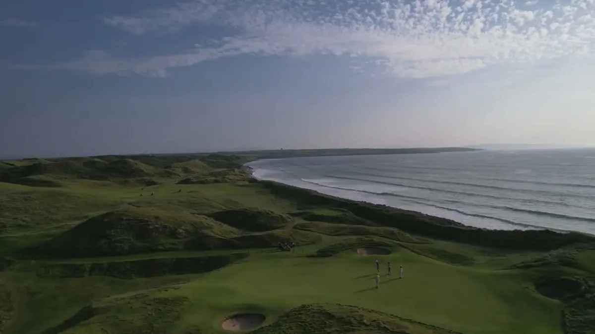 Golfers on the coastal links at Ballybunion Golf Club above the Atlantic